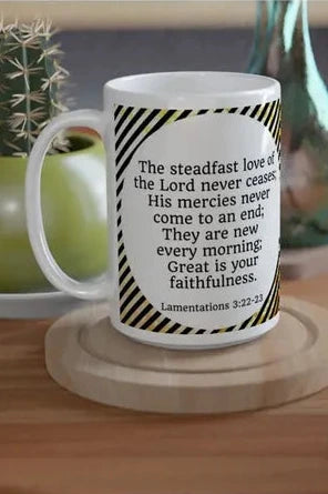 Mug with text on a wooden table with plants