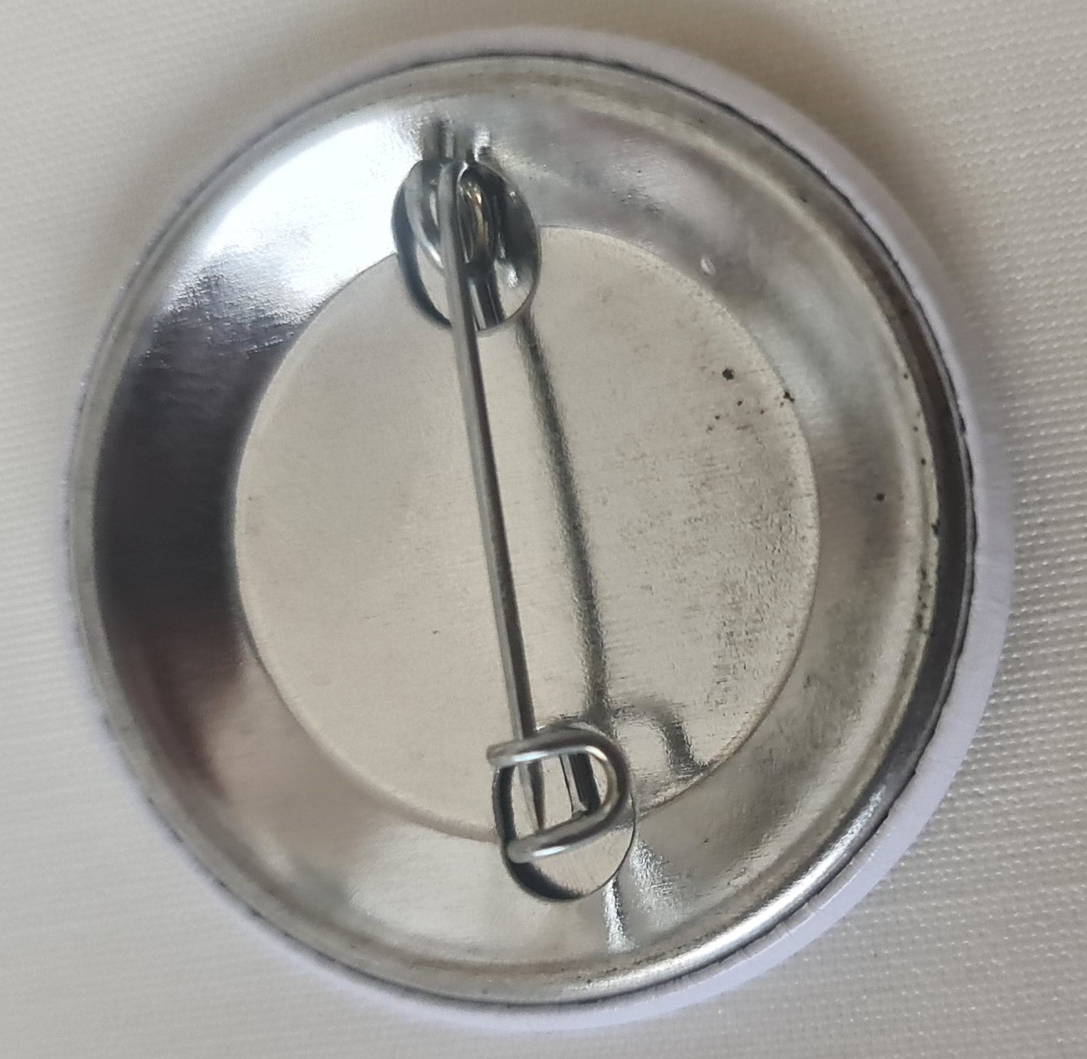 pin back of Embrace Melanin badge