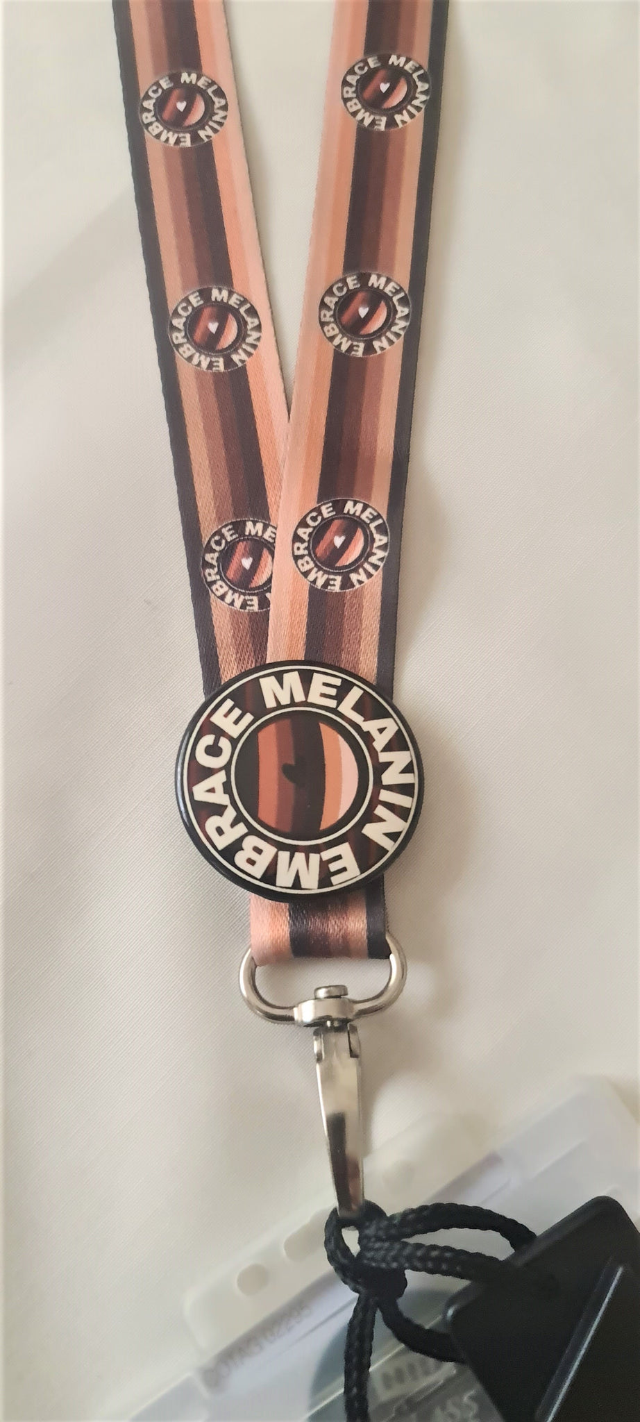 Embrace Melanin lanyard with Embrace Melanin badge.  